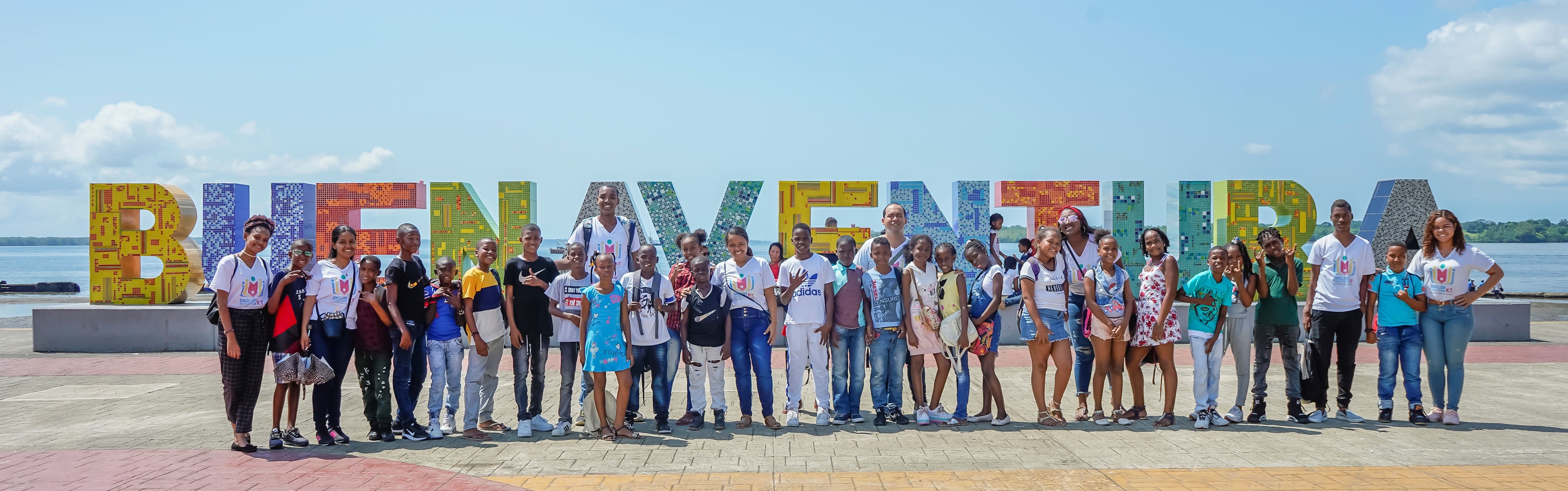 la imagen puede contener a un grupo de personas entre niños,jovenes y adultos posando alegres.